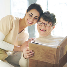 caregiver and senior woman reading