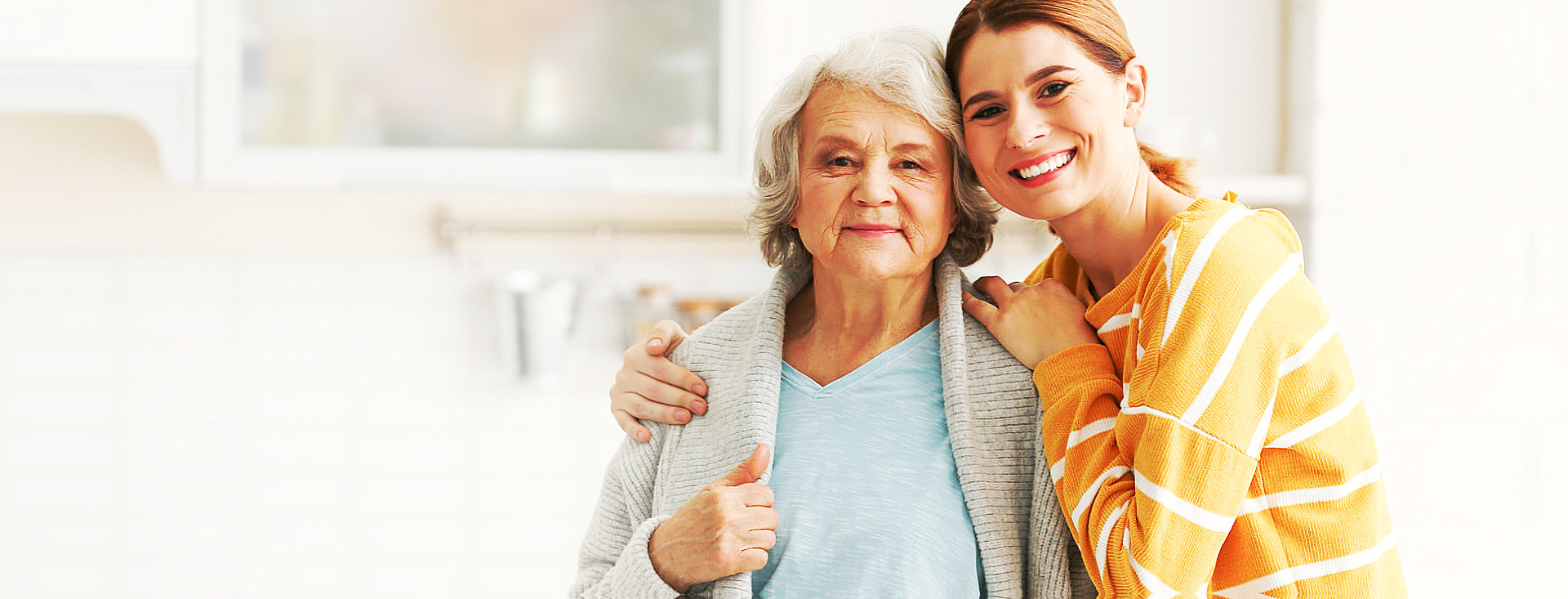 smiling caregiver and senior woman