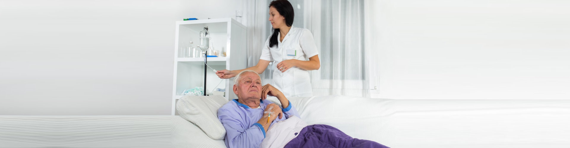 nurse checking elder man's dextrose